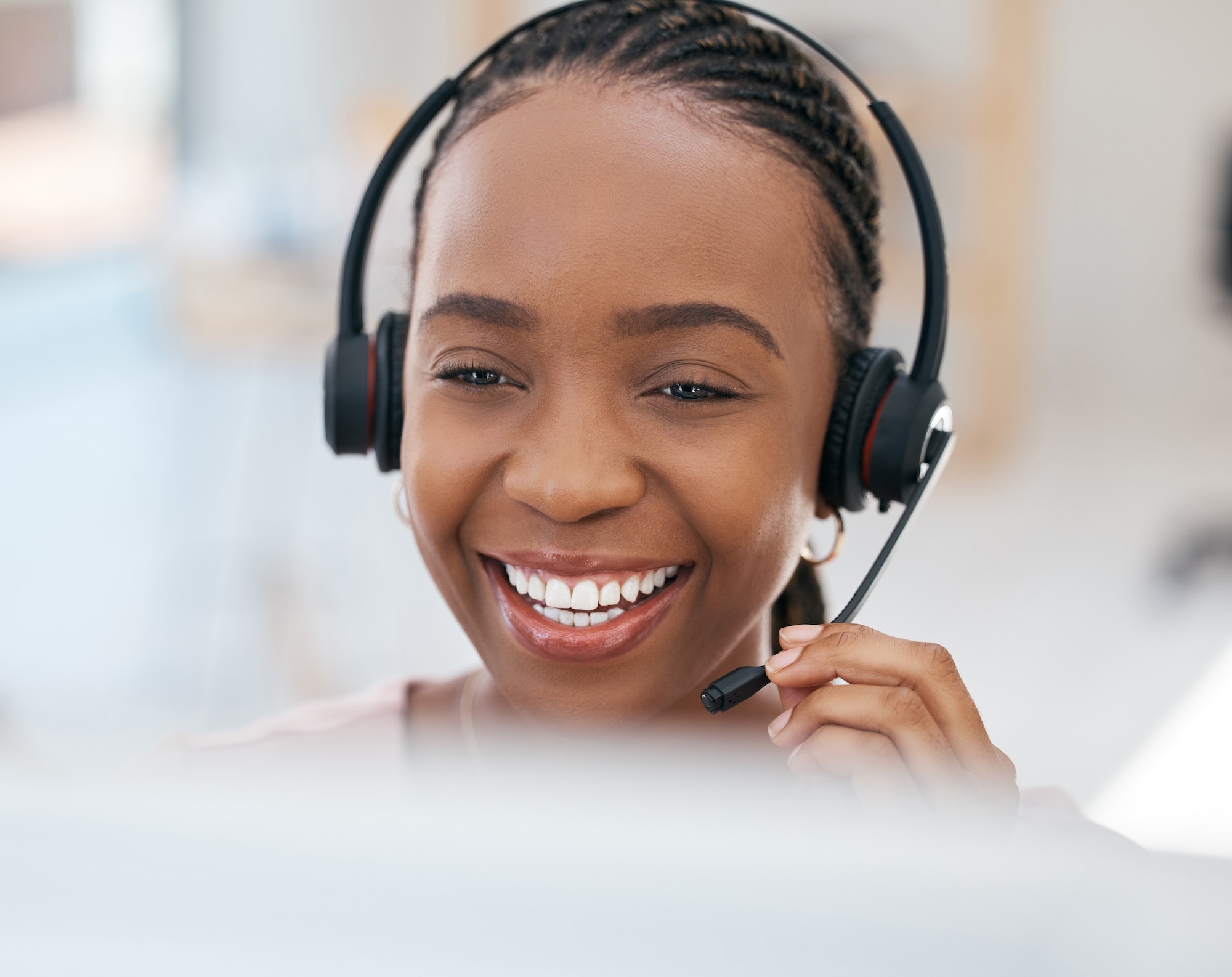 Black woman, smile and consulting in call center, contact us or telemarketing communication at the
